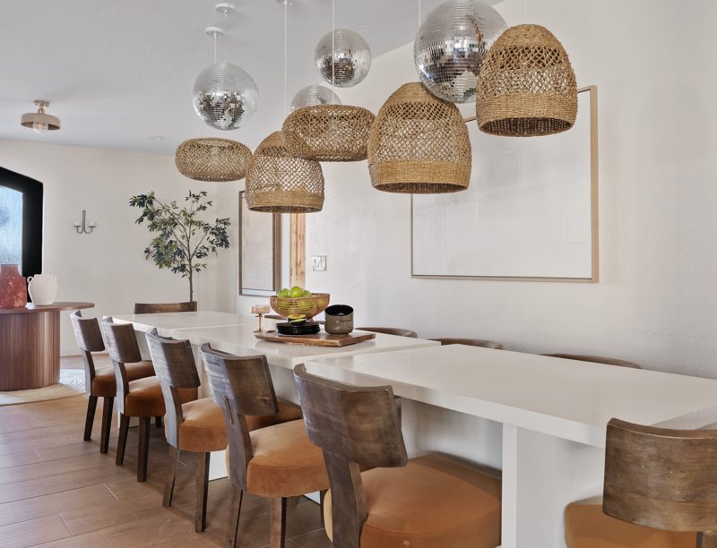 The dining table under rattan pendants