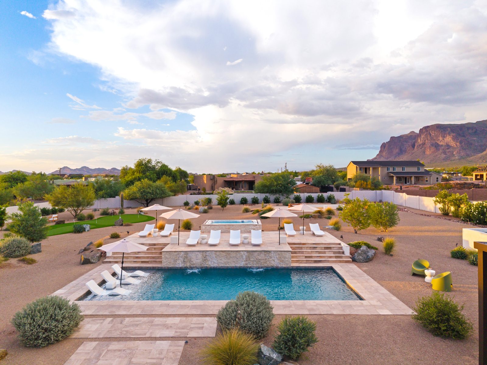 Aerial view of La Serena, a five bedroom house on an acre in Apache Junction, with the Superstition Mountains rising behind it.